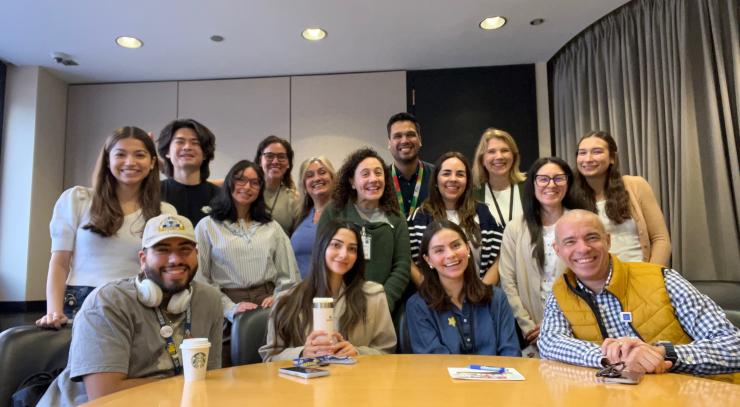 photo of 15 people standing behind a desk