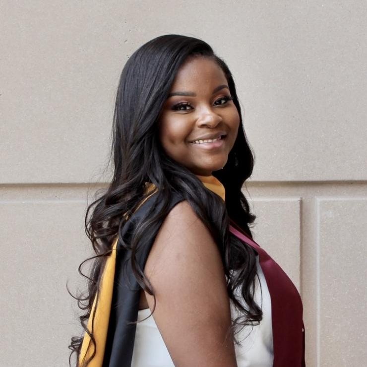 Woman smiling in front of grey background