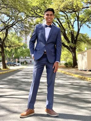 Man standing in the middle of the street in a grey suit