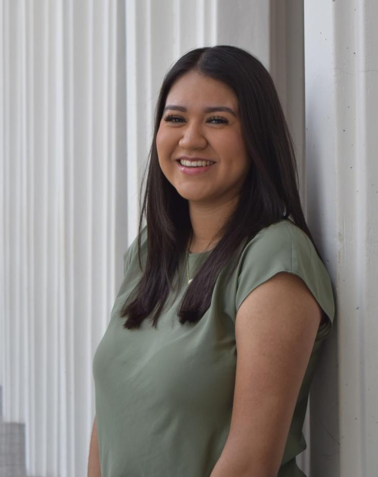 woman smiling in front of grey background