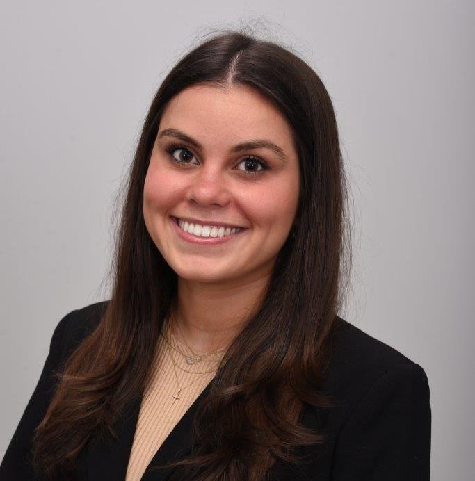 woman smiling in front of grey background