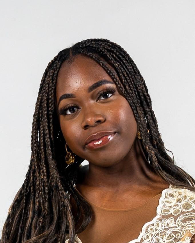 woman smiling in front of grey background
