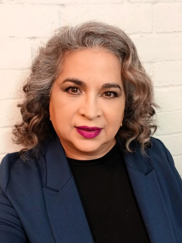 woman with shoulder length hair smiling lightly