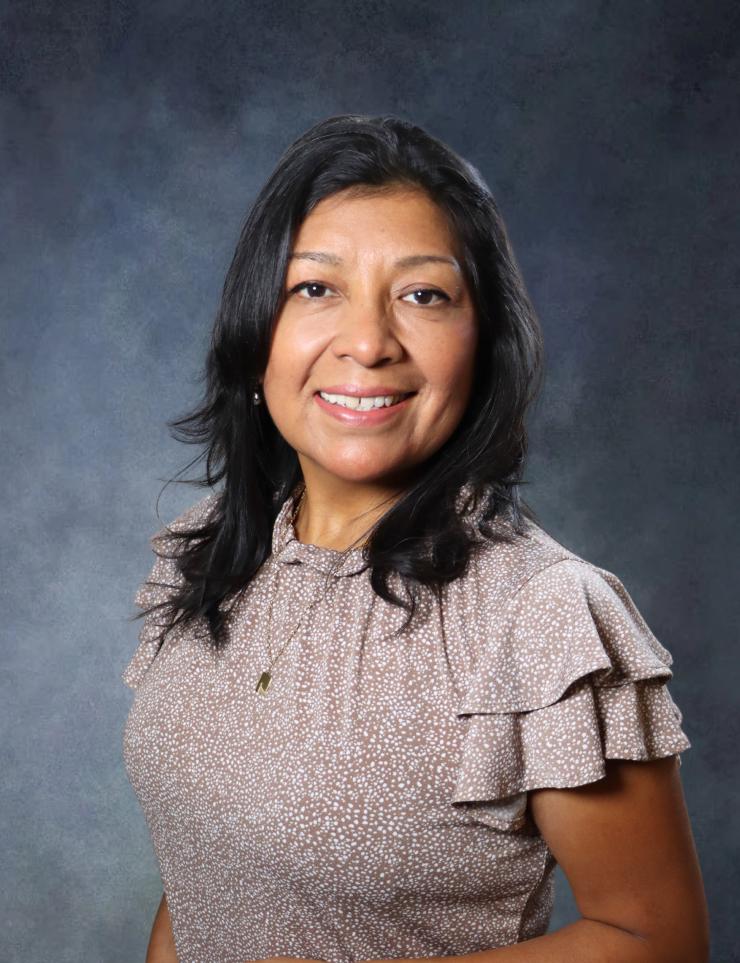 woman with dark shoulder length hair smiling