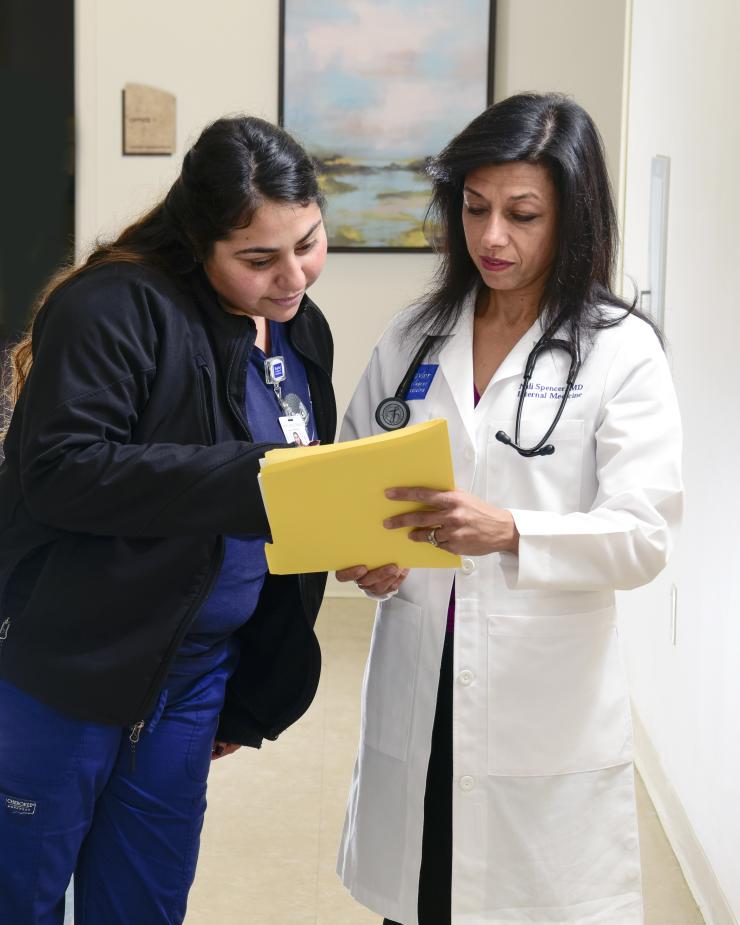 a doctor and a nurse looking at a file
