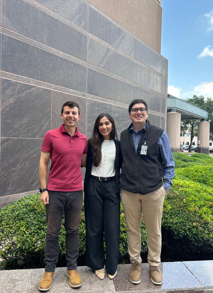 3 people standing outside smiling