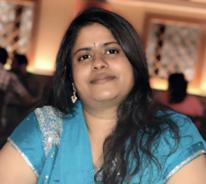 woman smiling in front of grey background