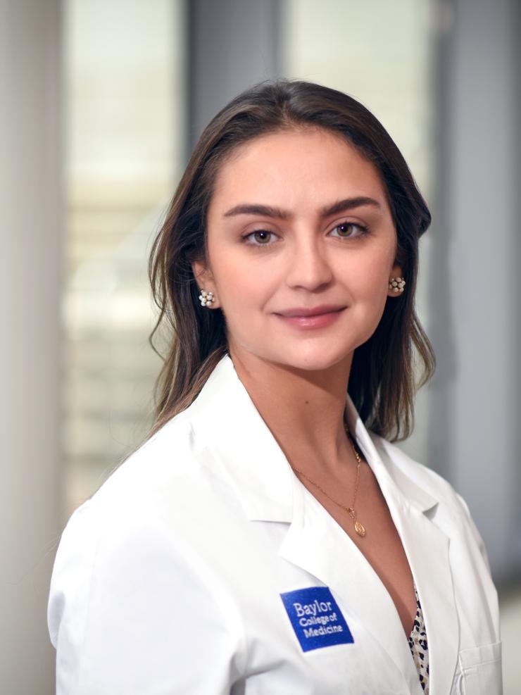 a woman with brown hair smiling lightly