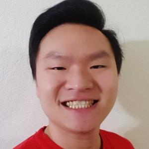 man smiling in front of grey background