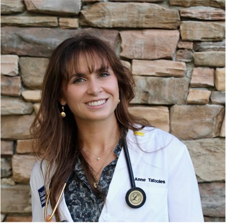 Woman standing in front of a brick wall
