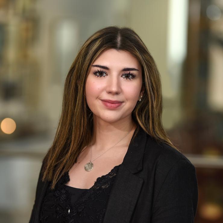 woman smiling in front of a grey background