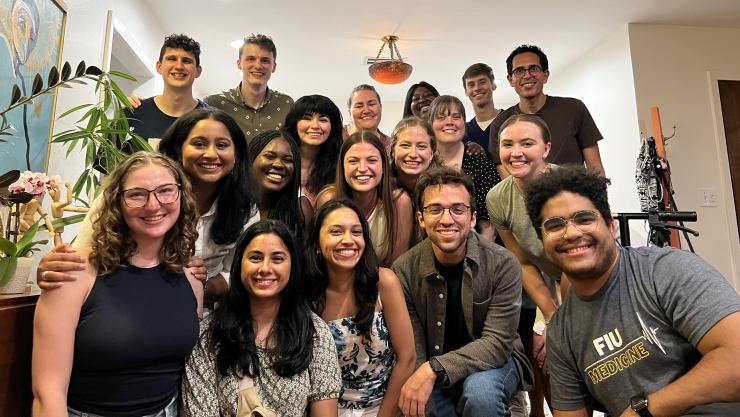 A large group of people shoulder-to-shoulder in rows, smiling.