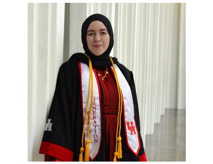 woman in UH graduation gown smiling