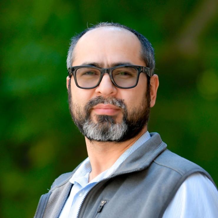 man with black glasses on smiling lightly