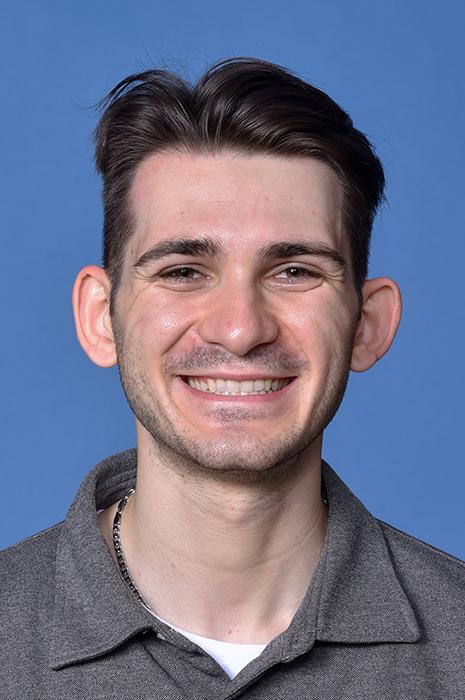 man with short brown hair smiling