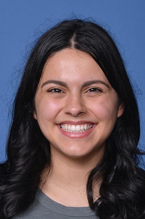 woman with dark curled hair smiling