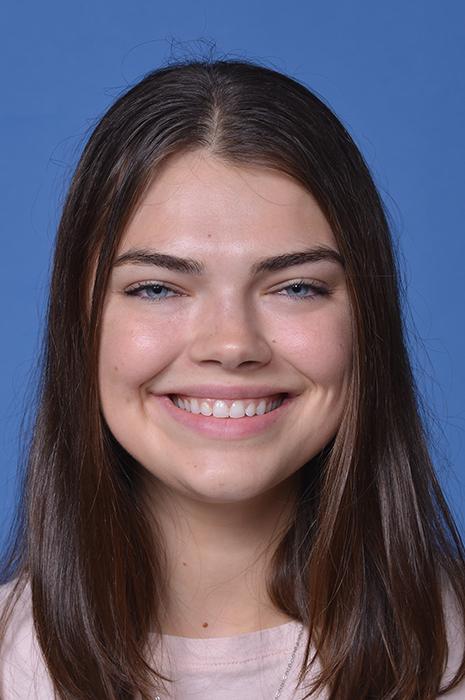 woman with brown, straight hair smiling