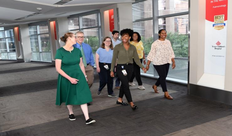 group of residents walking down hall