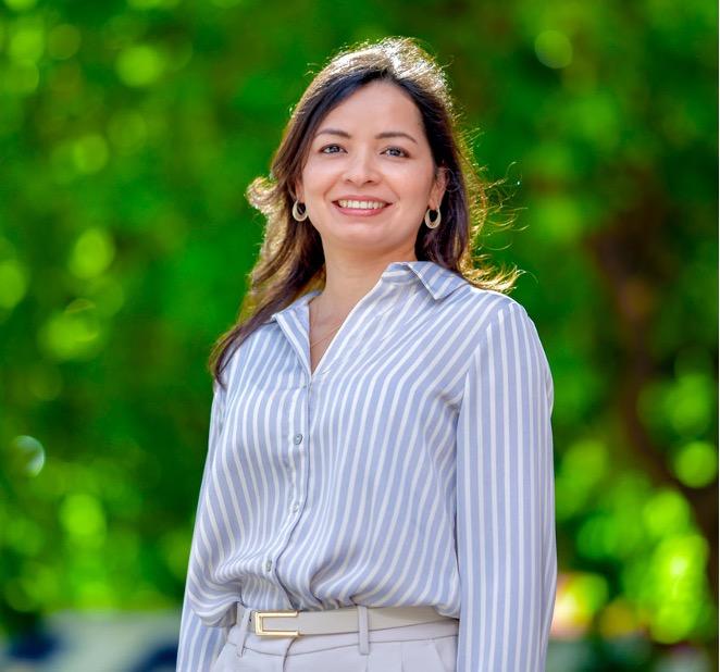 woman in a striped button-down smiling