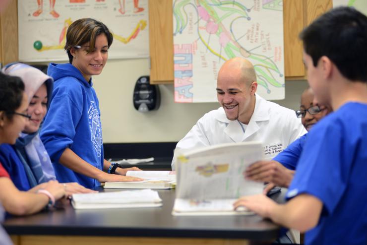 Dr. Ronald Cotton with students at his alma mater, DeBakey High School.