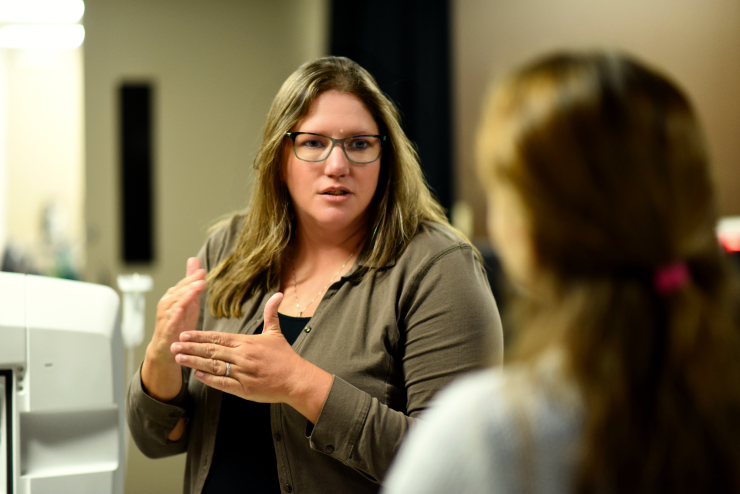 Dr. Mary Dickinson talks with a colleague in her research lab.