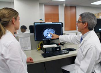 William Fisher, M.D., consults with a general surgery resident.
