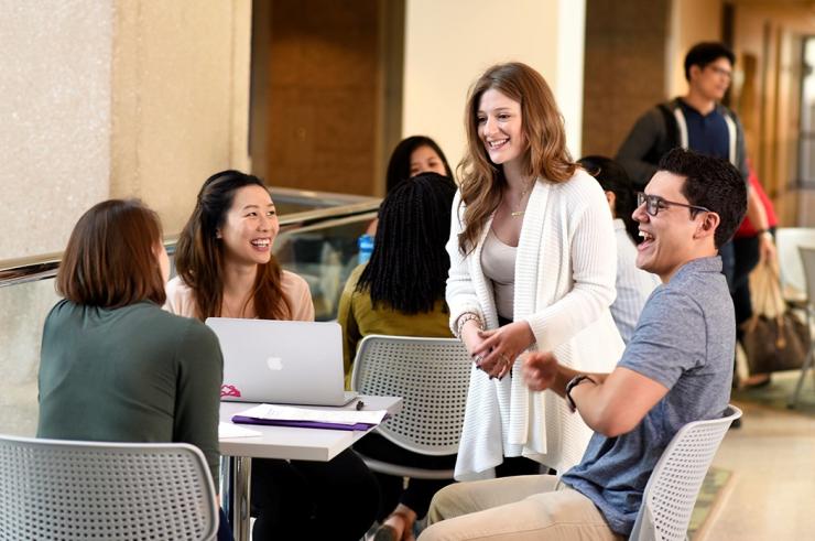 Graduate students gathering on campus.