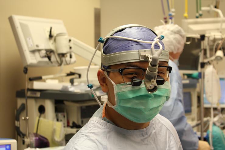 A resident gains operative experience with the guidance of a faculty member.