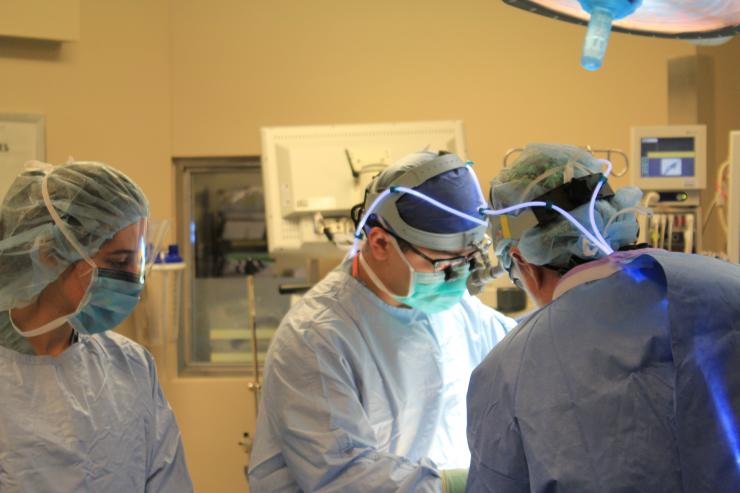 General surgery resident assists attending