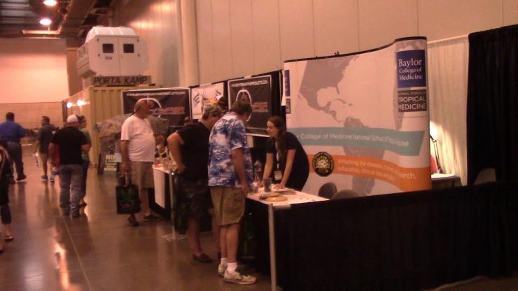 Researchers from the Laboratory for Zoonotic and Viral Diseases givee information and take blood samples from hunters at conventions around the state.