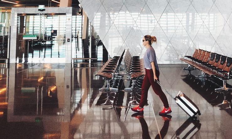 A person walking through an empty airport.