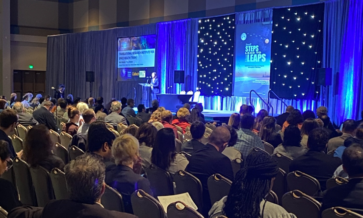 An audience listening to a speaker during the NASA's Human Research Program.