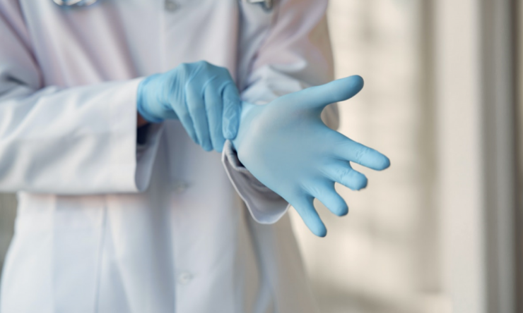 Doctor putting on gloves