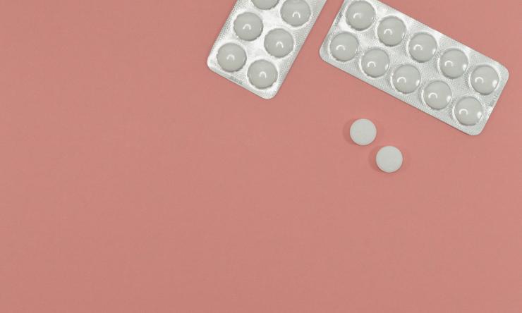 White pill on pink background