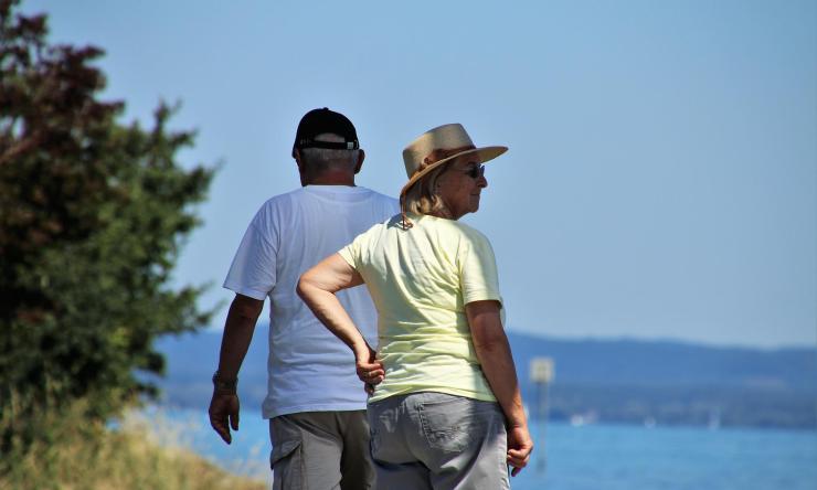 Older couple walking in the shade