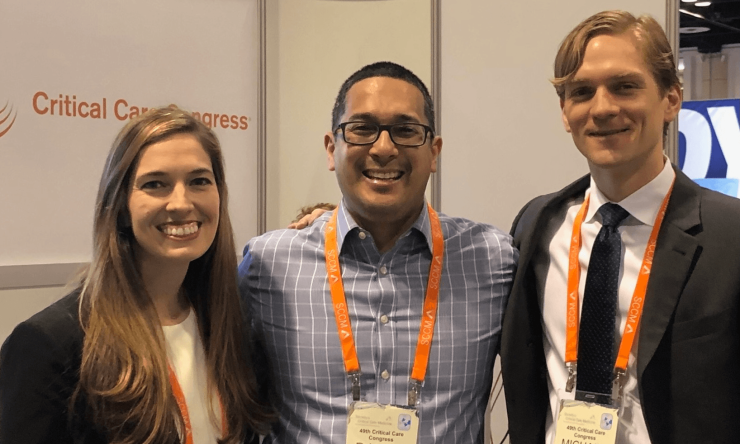 Three Pediatric Critical Care Fellows stand shoulder-to-shoulder during the Critical Care Congress event.