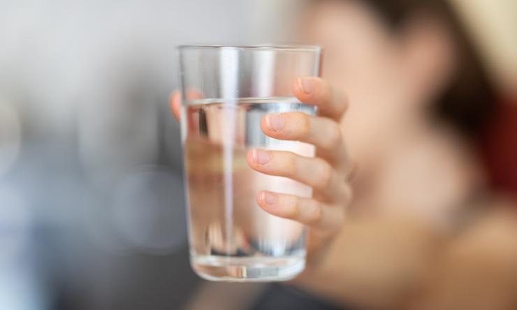 Woman holding water glass