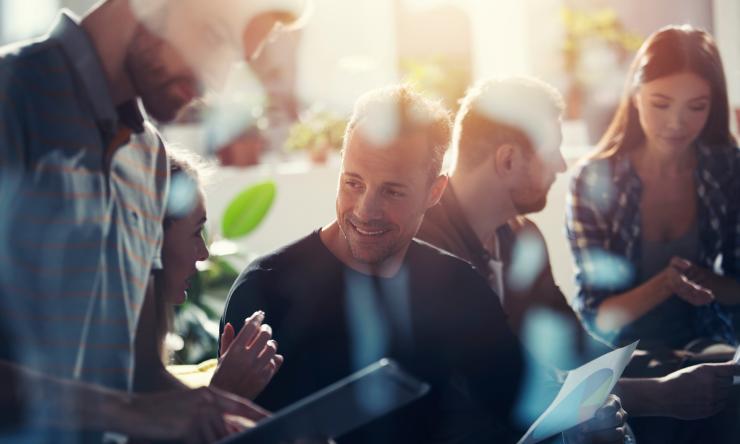 A group of people connecting by having conversations.