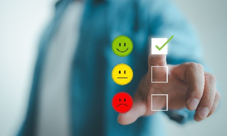 A person making a check box select of red, yellow or green smiley faces.