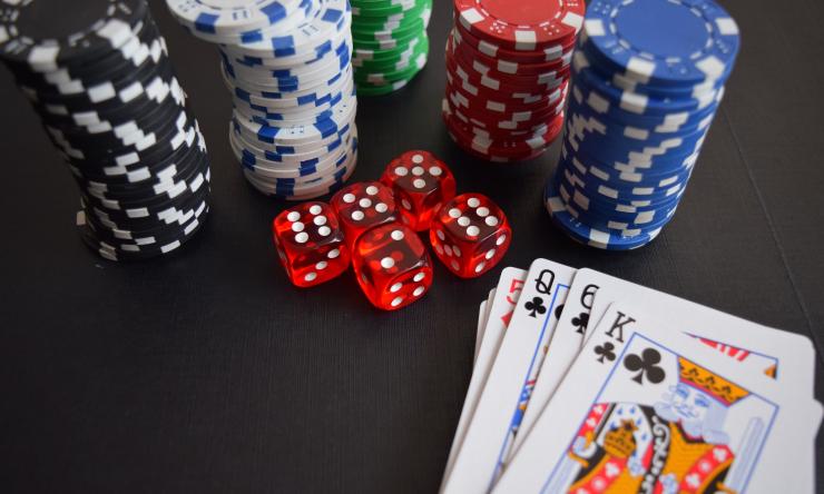 Close up of poker chips, red dice and playing cards. 