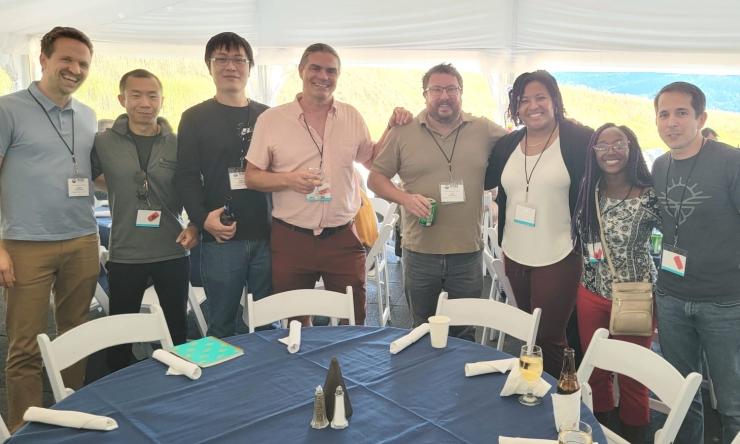 Members of the Jason Mills Lab pose at an outdoor event