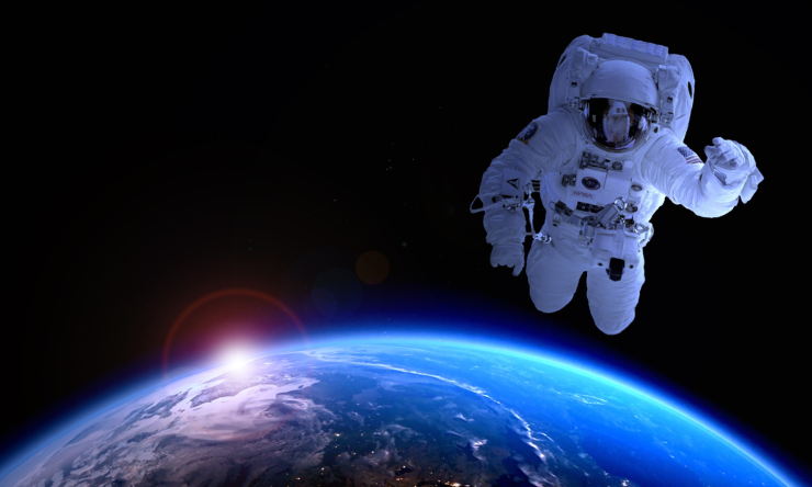 An astronaut in space above Earth