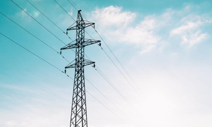 photograph of power lines with a blue sky background