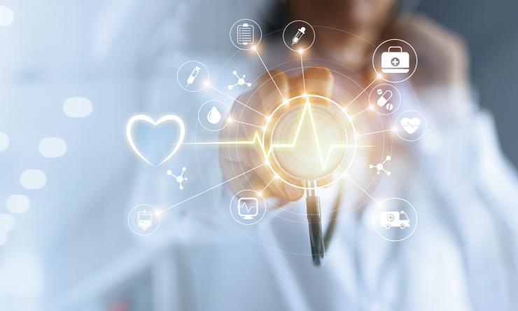 Doctor pointing to a computer image of health related symbols