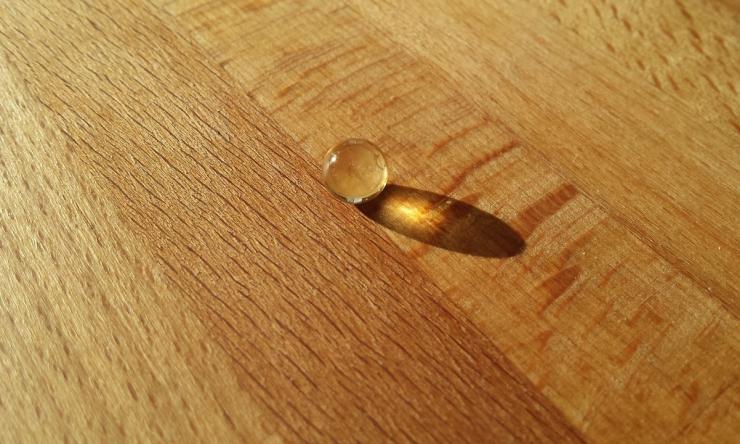 Photo of a vitamin D pill on a wooden table top. 