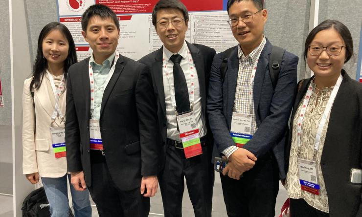 group of people in front of a poster