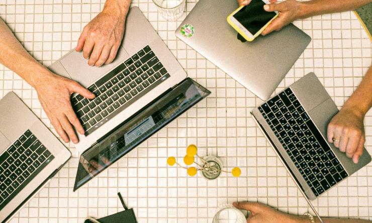 people working with multiple electronic devices