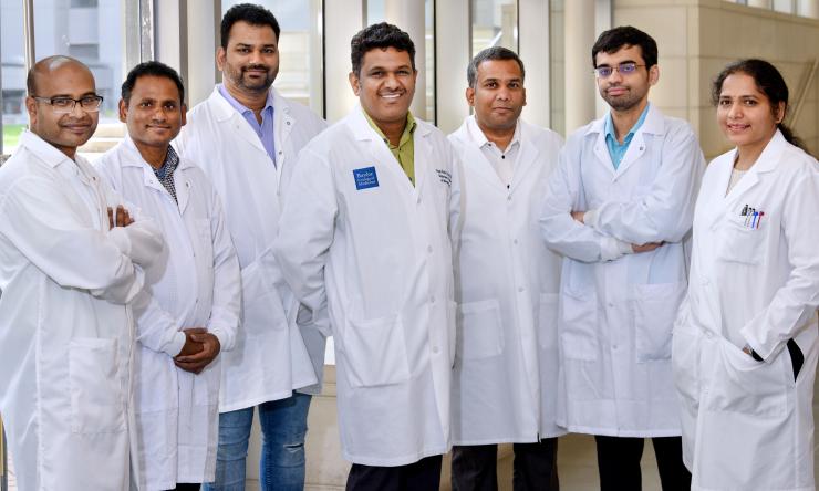 group of doctors standing in front of a window