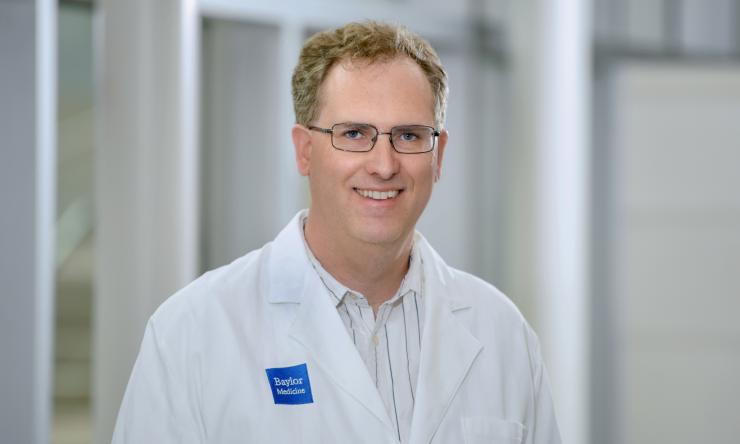 Photo of man smiling wearing glasses