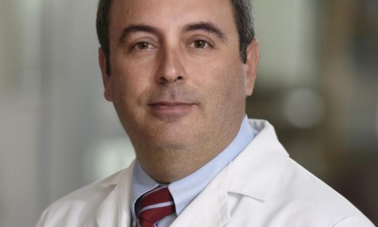 man smiling in front of grey background